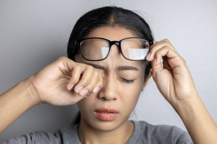 young-woman-with-eye-pain-gray-background-asian-woman-is-suffering-eye-pain-women-hold-glasses-suffer-from-eye-pain 1 Dr. Chen Eye Examination - 10/10 Optics